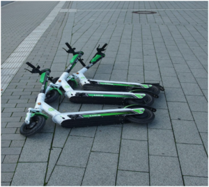 Electric scooters resting on a pavement